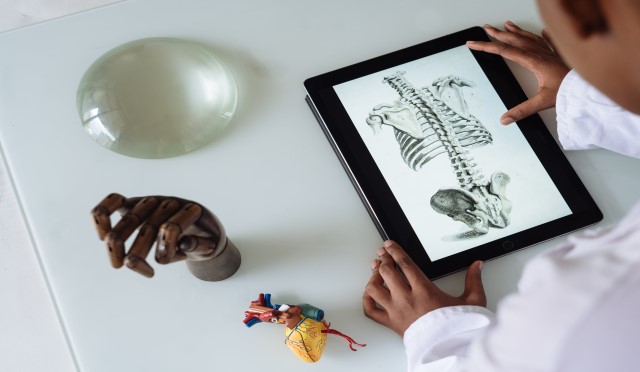 A doctor reviewing patient data on a tablet, symbolizing digital healthcare solutions.